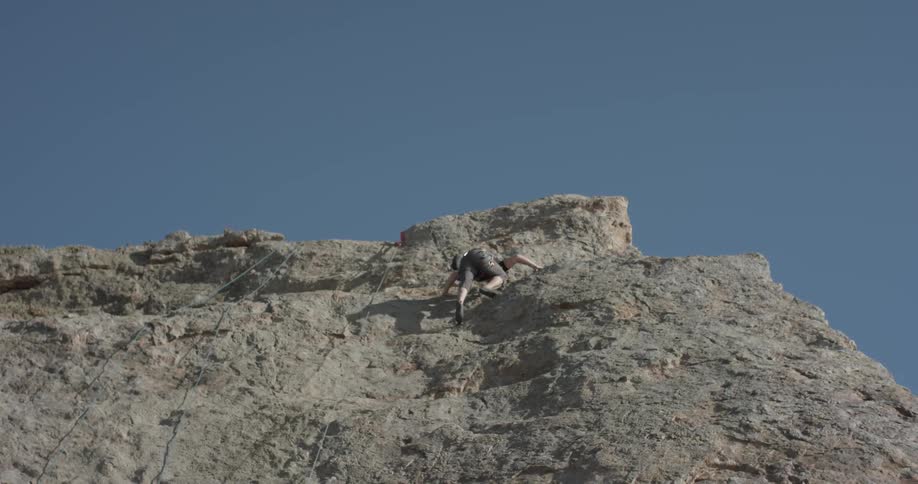 Man Climbing Wall By The Beach