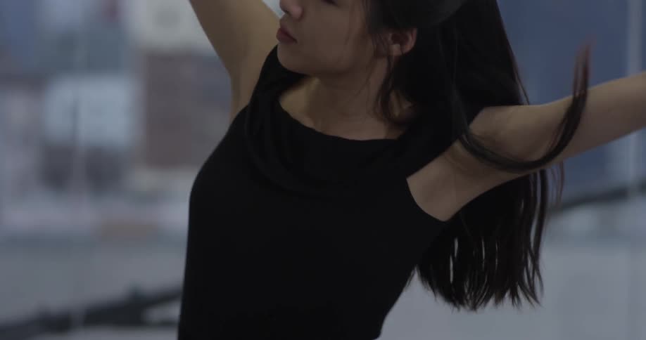 A woman dancing in an urban area