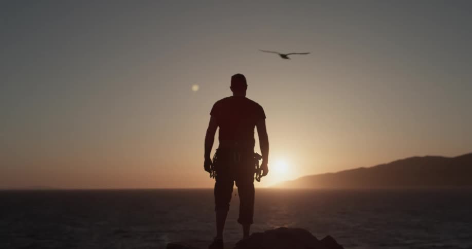 Man Climbing Wall By The Beach