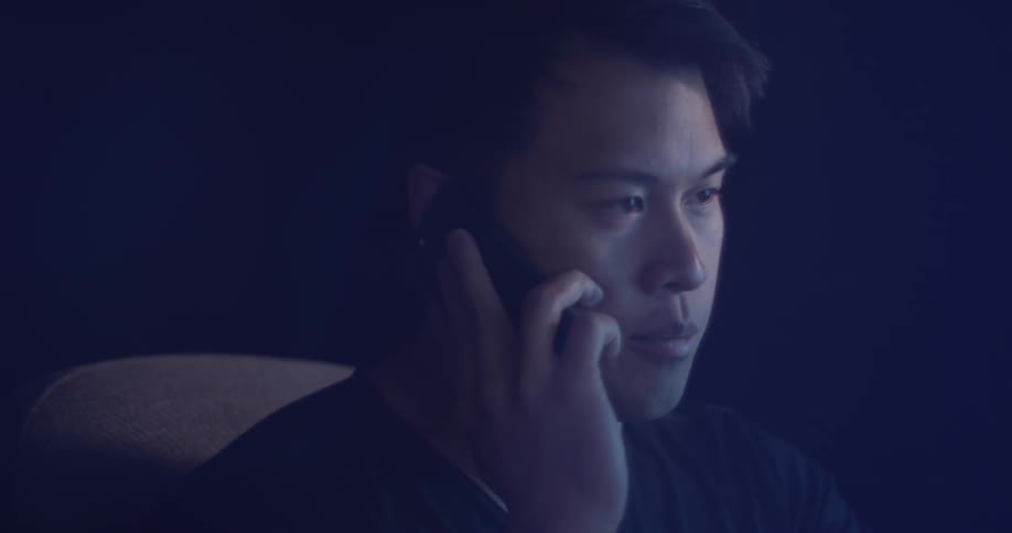 A man holds a cell phone to his ear and his talking