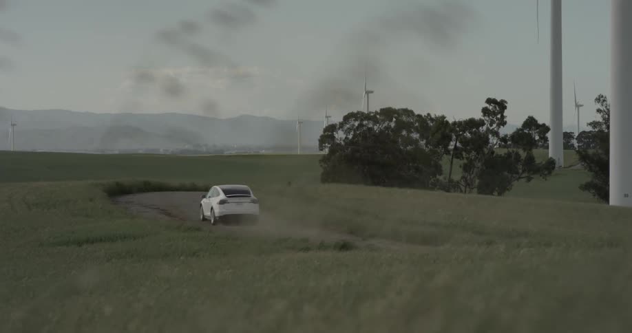 Speeding around the curve the white car doesn't even notice the sunset in the distance