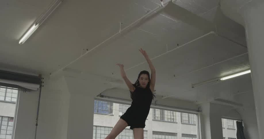 A woman that is running and jumping in a studio