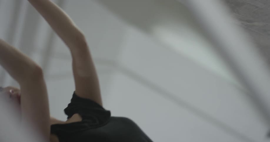 A woman using large arm movements in a dance