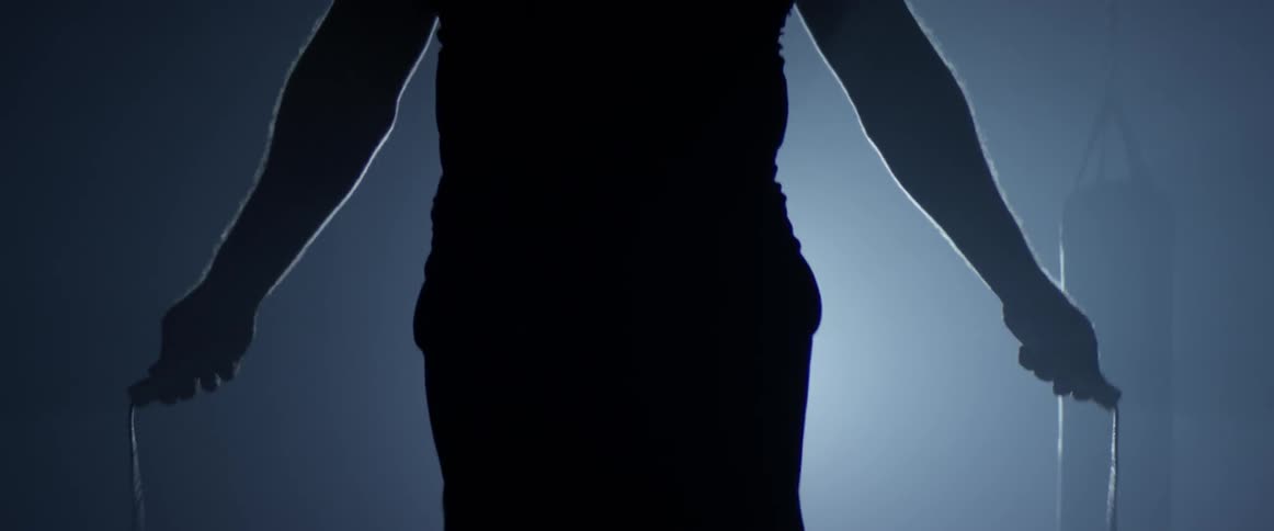 A man is jumping rope indoors