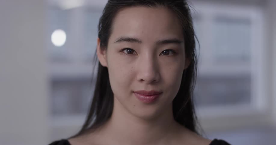 A woman is smiling indoors