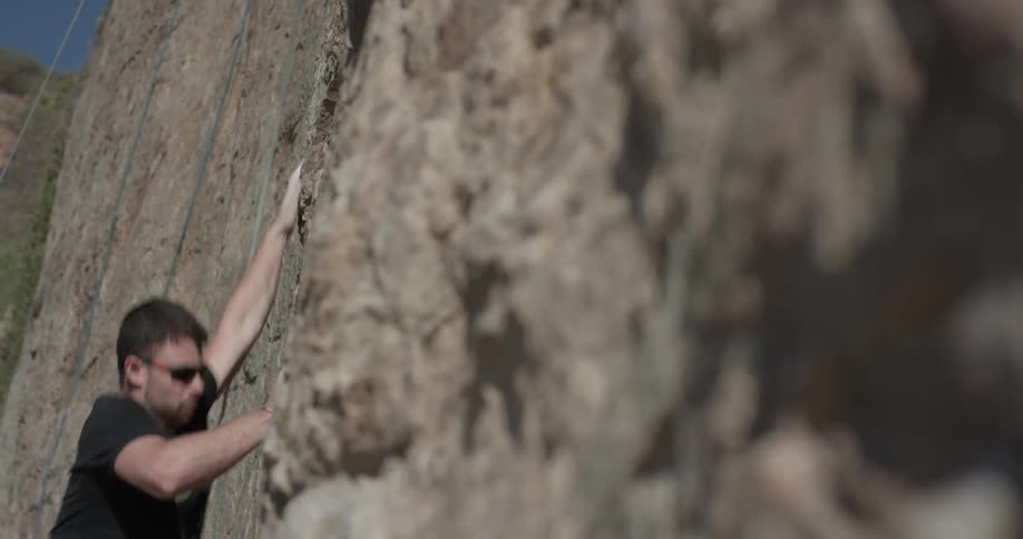 A man slips and falls from the side of the cliff