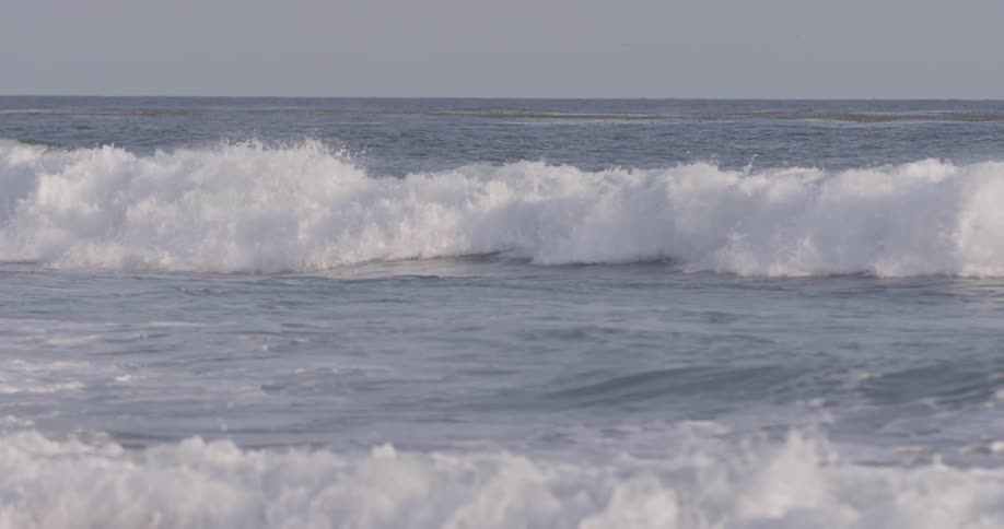 A man riding on a surfboard on the ocean