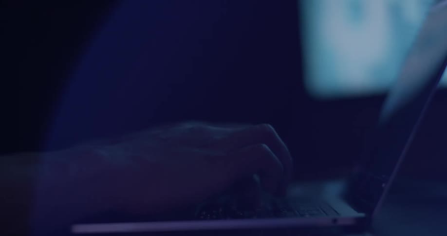 Fingers typing on a laptop keyboard