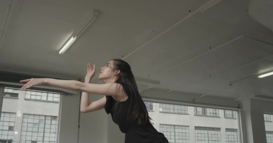 A woman leaps through the air and dances