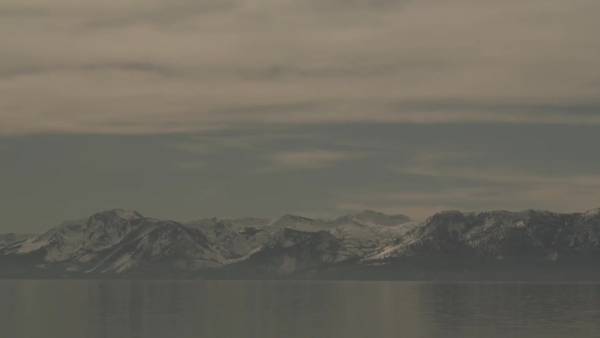 Distant snowy mountains and overcast sky