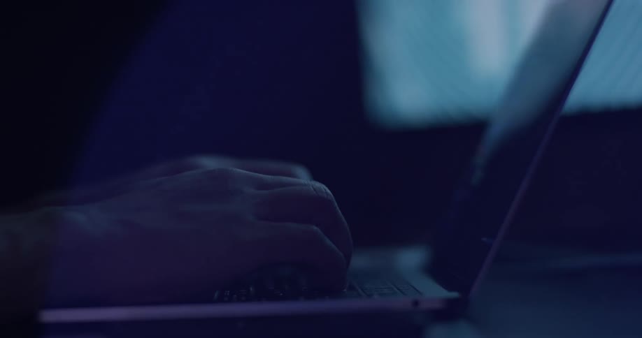 A person typing with a laptop