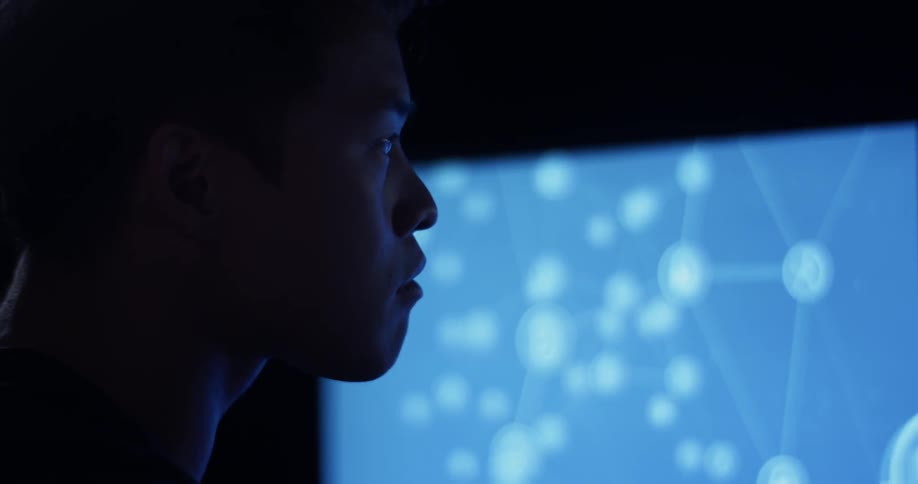 A woman that is looking at a graph on a screen