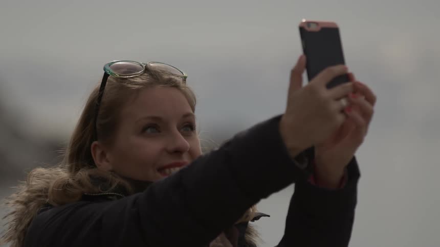 Woman takes a selfie with her camera