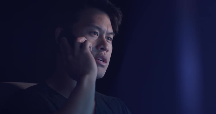 A man with a cell phone to his ear and talking