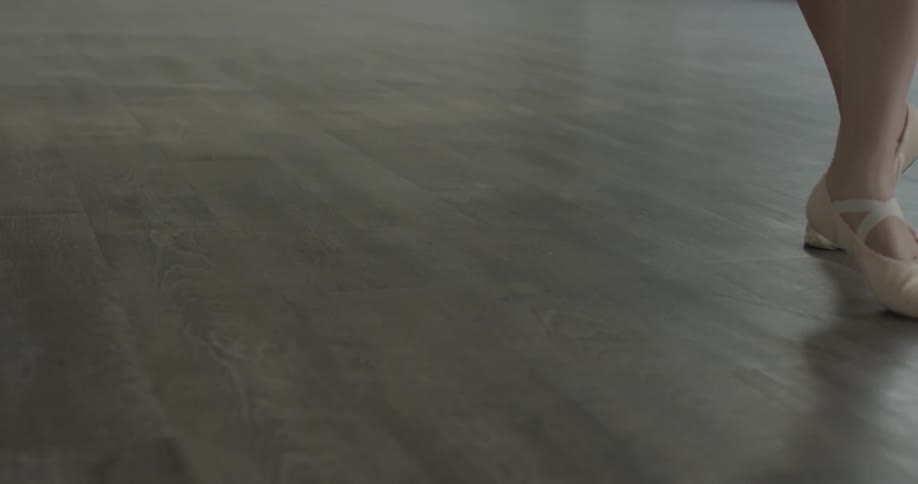 A woman dancing on wooden floors