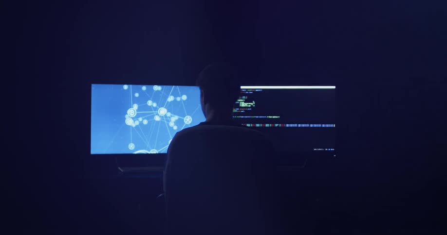 Man Coding On Computer In Dark Room