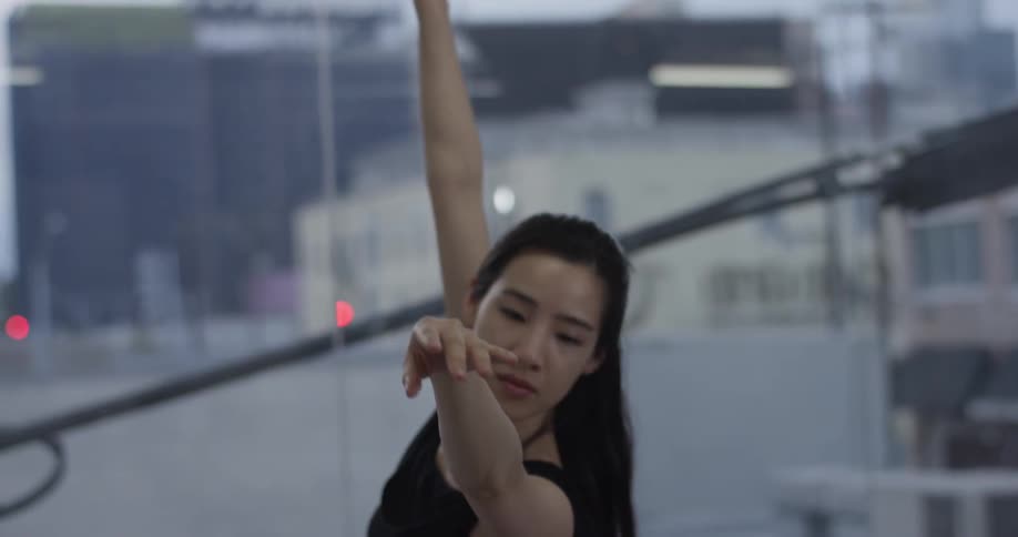 A woman is raising her arms dancing