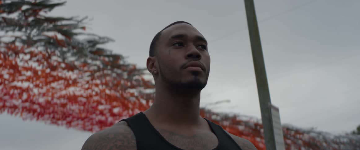 Man stands still while looking around on a cloudy day