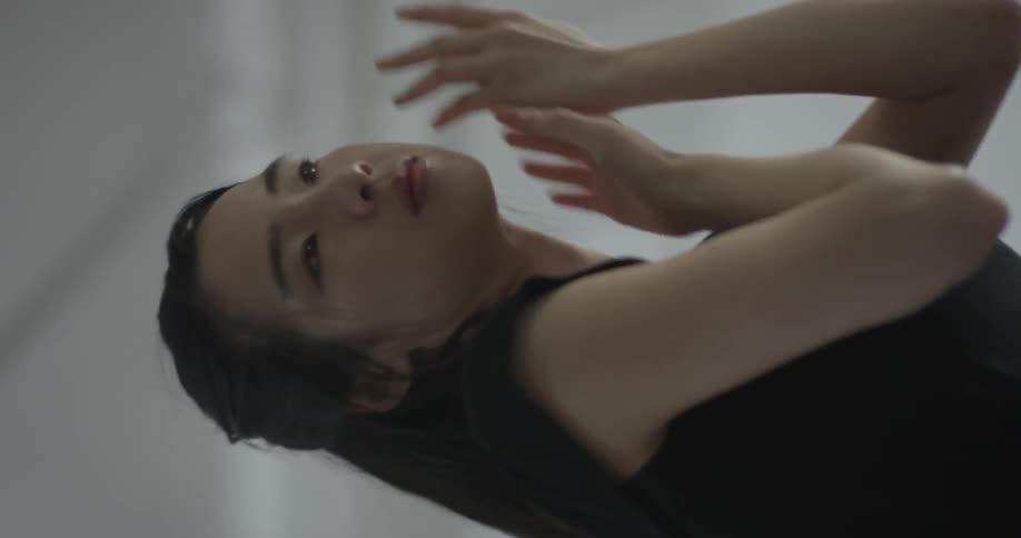 A woman motions her hands while she is dancing