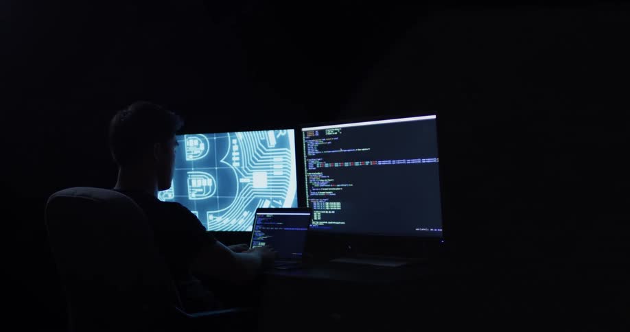 Man Coding On Computer In Dark Room