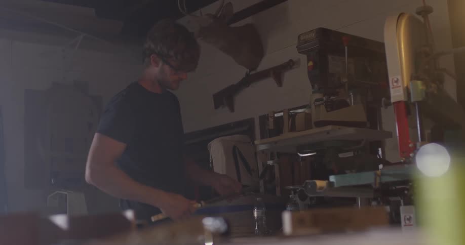 A man takes a cover off of a tool
