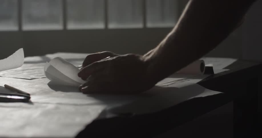 A person drawing on some paper with a pencil