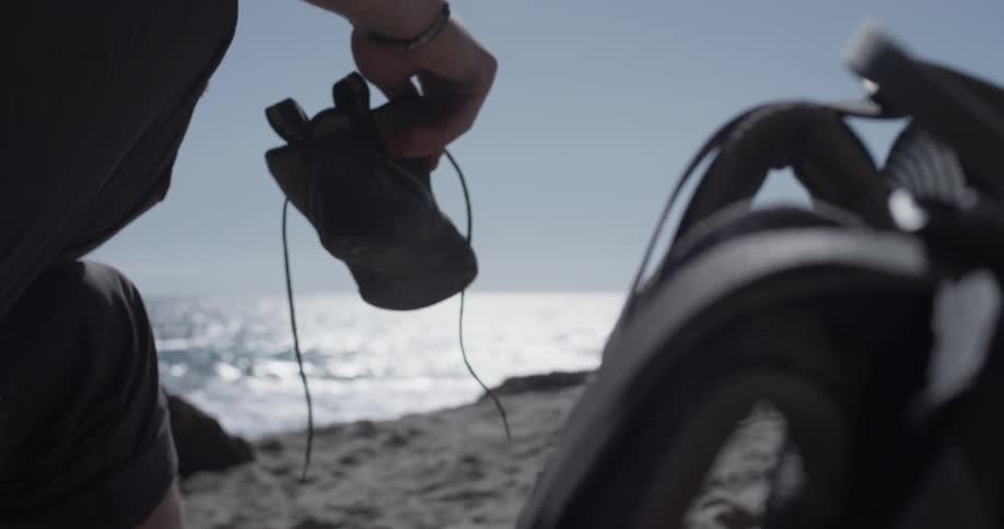 A man is putting on his shoes