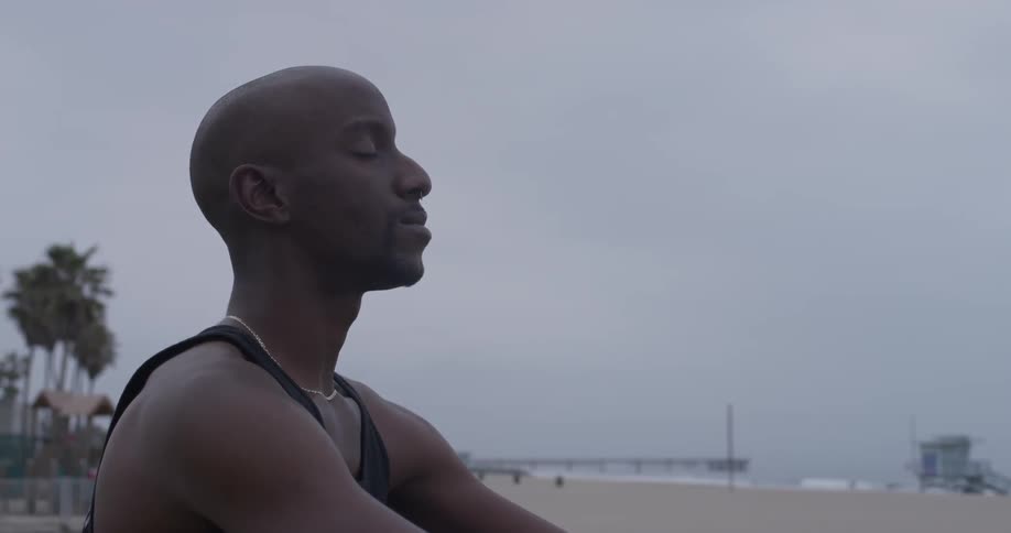 Man Meditating Outside By The Beach