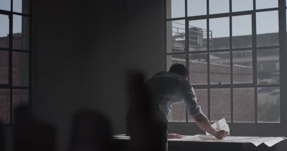 A man is writing on a piece of paper