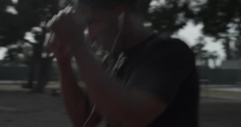 A man that is punching at the air in a park