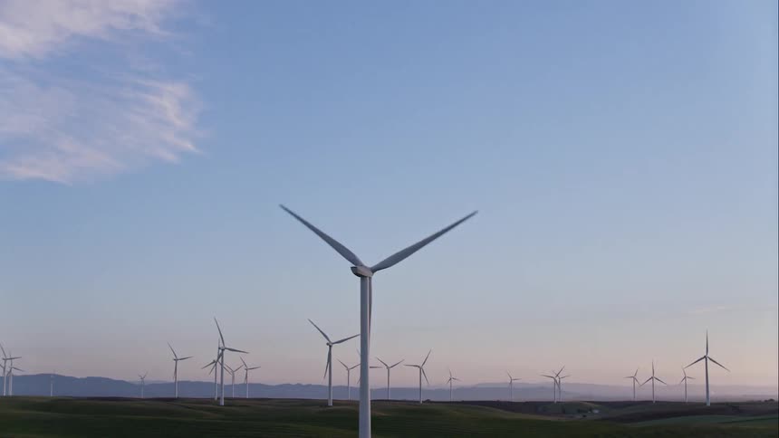 Windmills spinning on a windmill farm creating clean energy