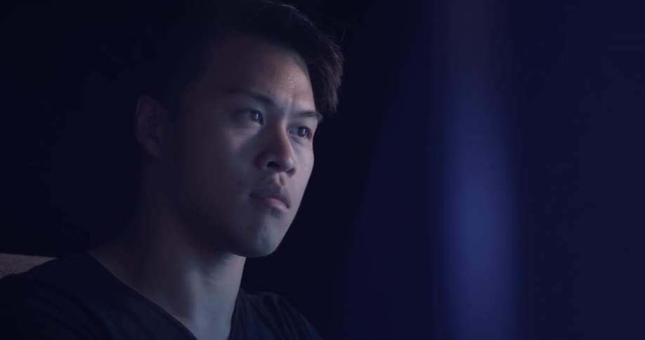 A man focused on a computer monitor