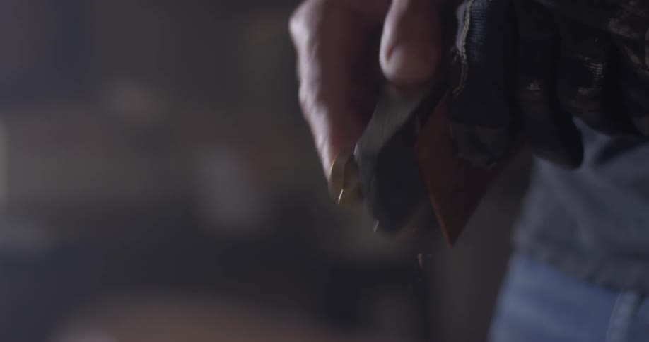 A person that is using a plane on a piece of wood