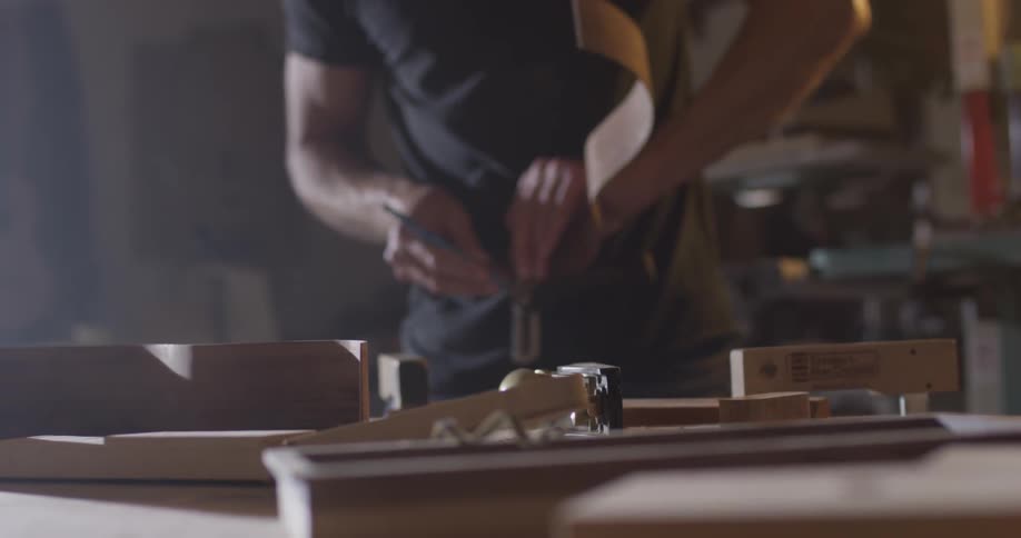 Carpenter Making Guitar In Workshop