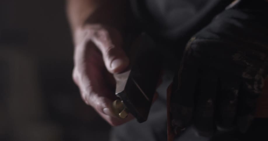 A person sanding and planing a piece of wood