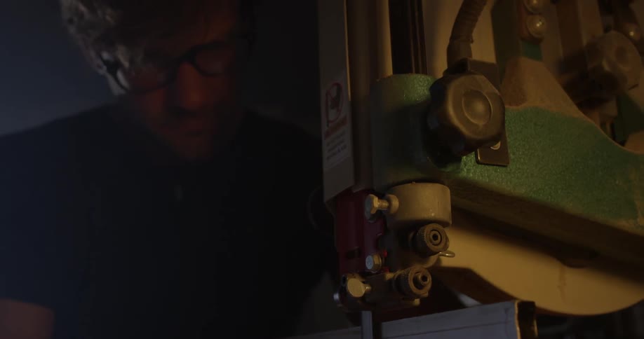 A man is moving a tool along an object