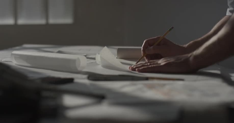 A woman is writing something down on paper