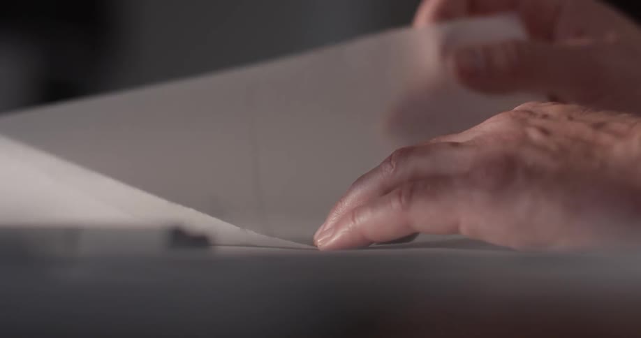 A person looking through some papers on a table