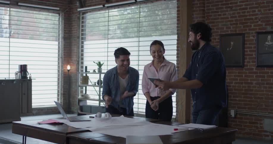 A man and woman looking at plans on a table