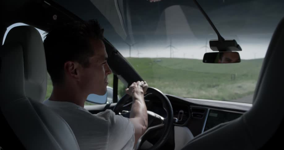 Man drives a vehicle in the country on a cloudy day