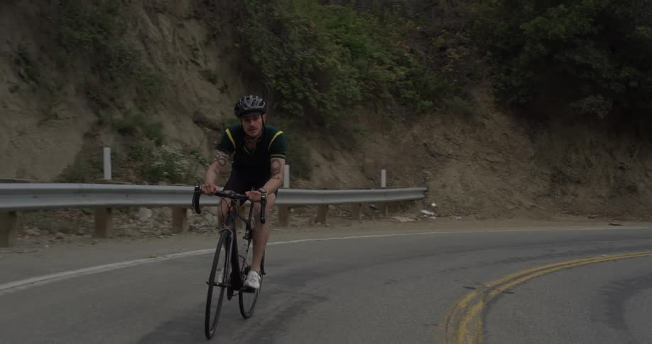 A man is riding his bicycle outside