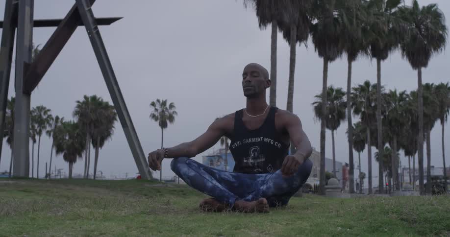 Man Meditating Outside By The Beach