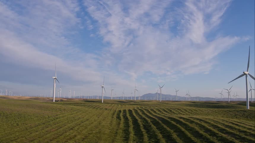 Aerial view of windmills in a field in the afternoon