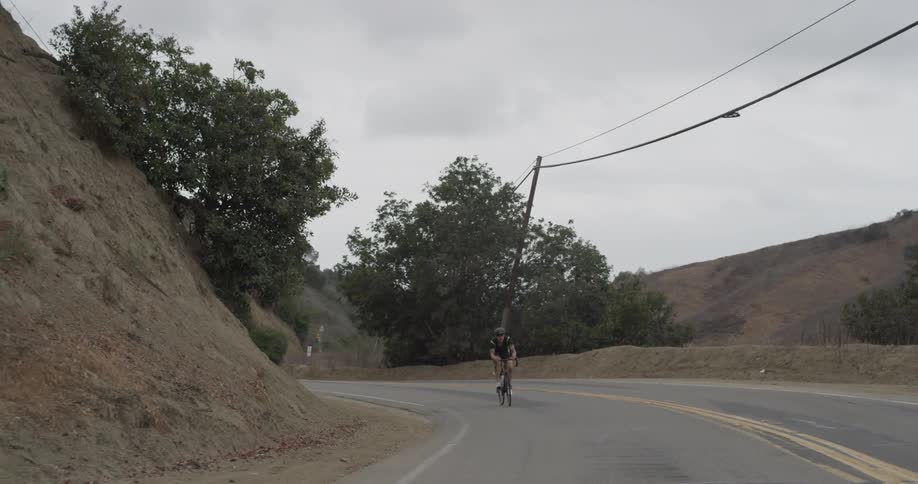 Cyclists On Hilly Roads