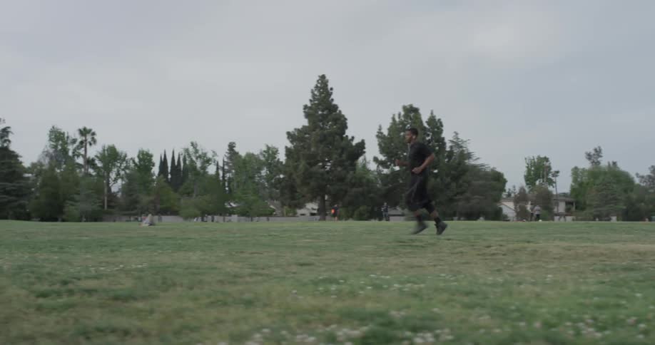 A man running in a grassy field