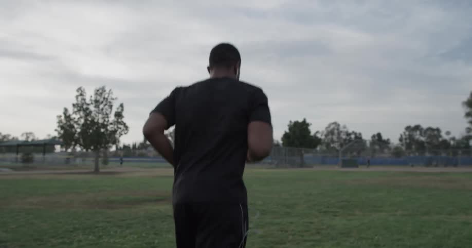 A person running in a field at a park