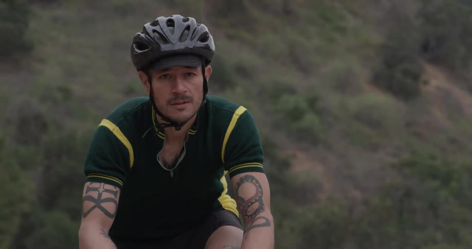 A man riding a bicycle up a mountain