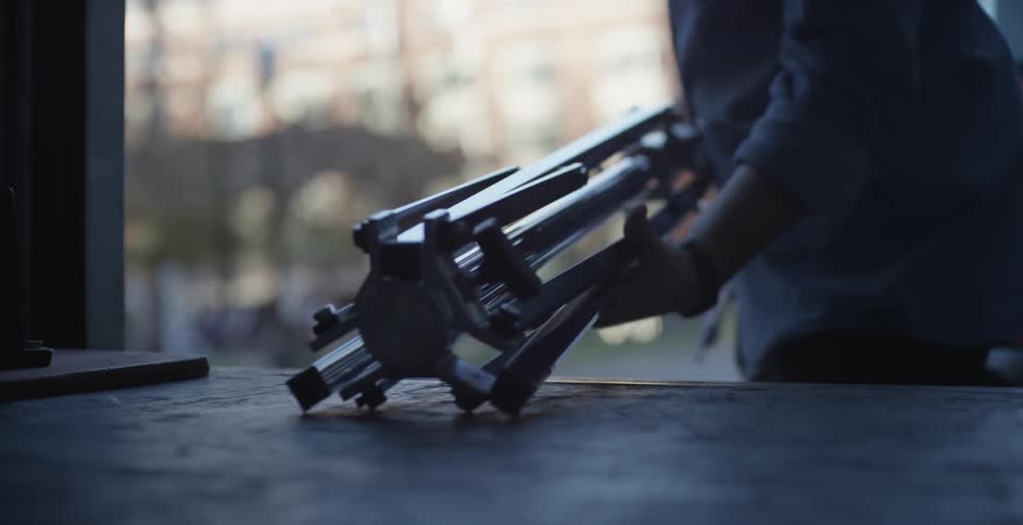 Man is preparing a tripod