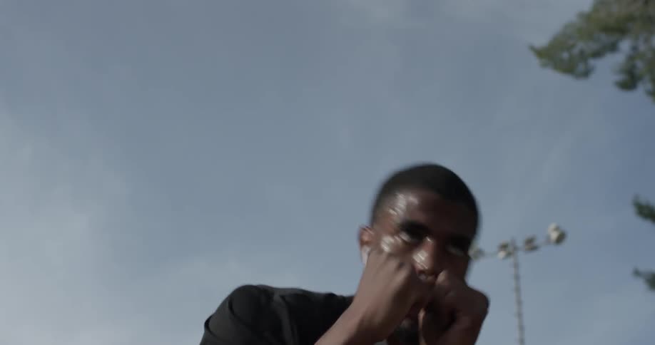A man jumping around making fighting jabs