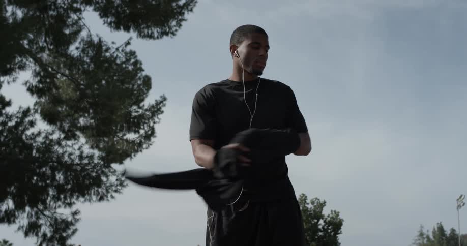 A man takes off his jacket and makes a little jump
